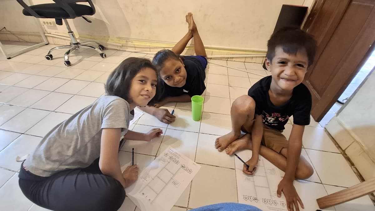 Children learning English in a Bali orphanage classroom